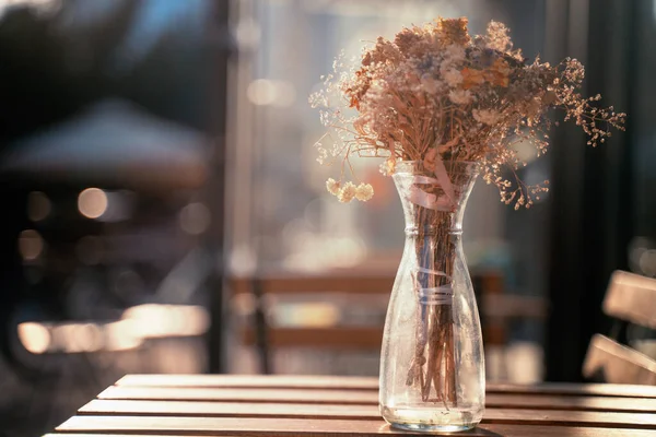 bouquet of dried flowers on a table of a street cafe, on a summer sunny day