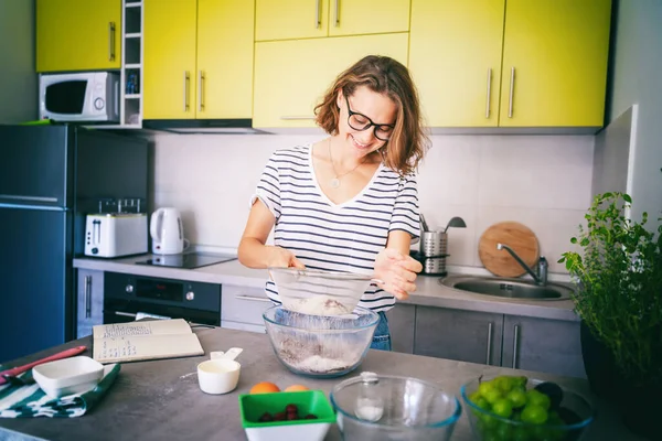 Güzel, genç bir kadın mutfakta tatlı hazırlıyor un, hobi ve eğlence, yemek konsepti seçiyor.