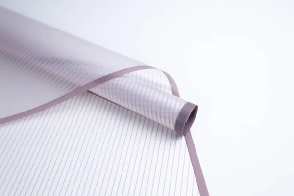 roll of floral packaging in lilac stripes on a white background