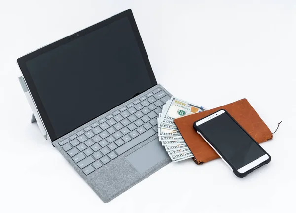 Laptop computer, cellphone and cash money