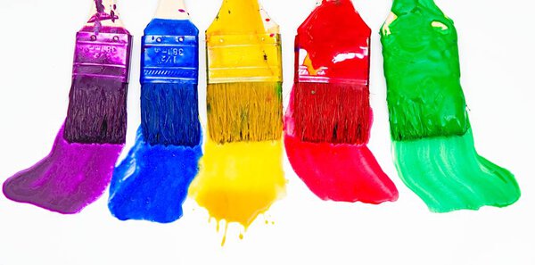 Brushes and paint , different colors , wall painting , rainbow colors                                