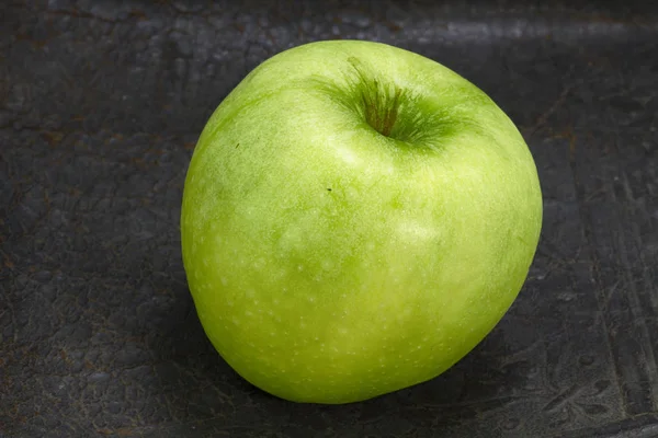 Green apple on black background.