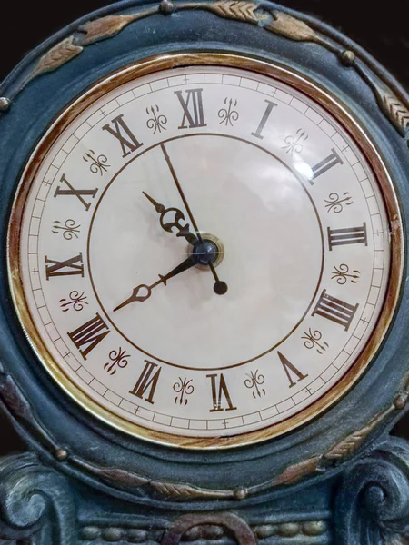 A beautiful antique clock showing the time of the day.
