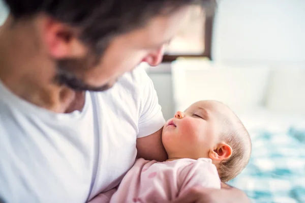 Father holding a sleeping toddler girl at home. — Stock Photo, Image