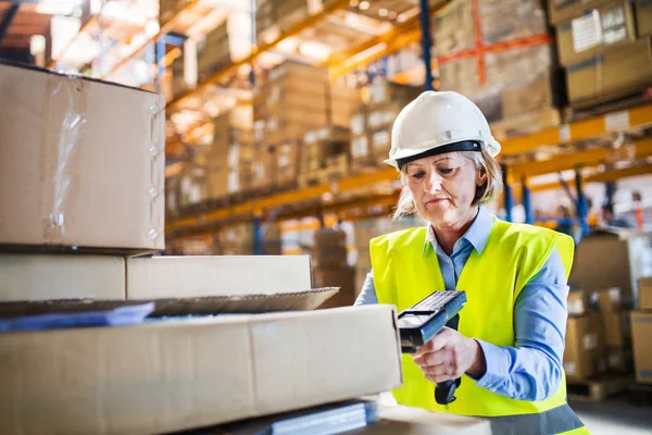 Senior warehouse woman worker working with barcode scanner. — Stock Photo, Image