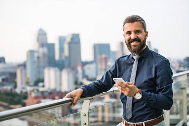 Smartphone konumu Londra görünümü panorama karşı olan işadamı portresi.