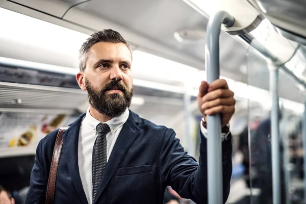 A portrait of a serious hipster businessman travelling by subway. — Stock Photo, Image
