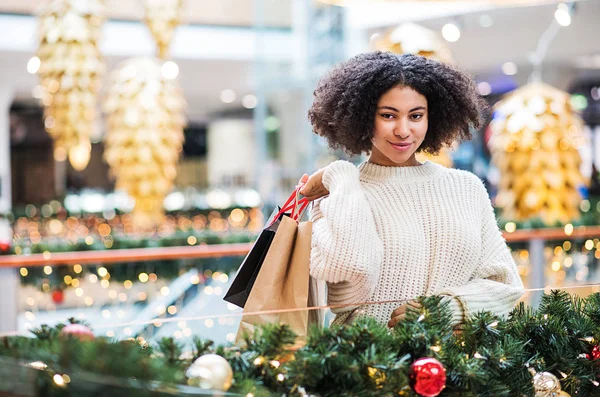 Un portrait d'adolescente avec des sacs en papier dans le centre commercial à Noël . — Photo