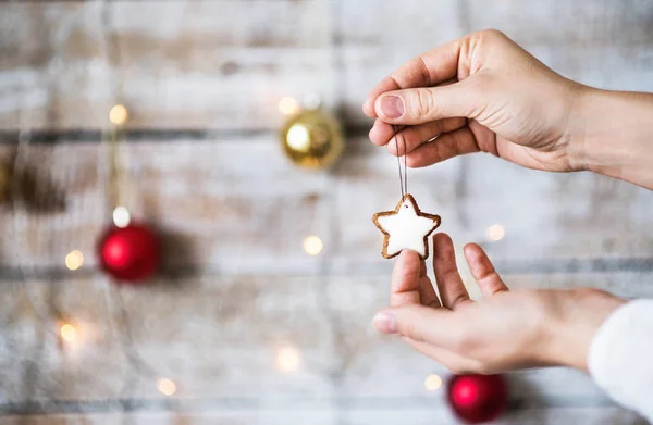 Manos femeninas sosteniendo decoraciones navideñas. Copiar espacio . — Foto de Stock