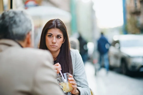 Man and woman business partners sitting in a cafe in city, talking. — Stock Photo, Image