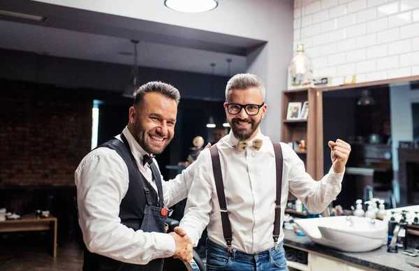 Hipster człowiek klienta uścisk dłoni z haidresser i fryzjerka w fryzjera. — Zdjęcie stockowe