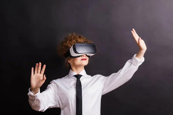 Portrait of a young woman with virtual reality goggles in a studio. — Stock Photo, Image