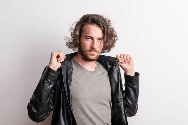 Portrait of a young man with black jacket in a studio. — Stock Photo, Image