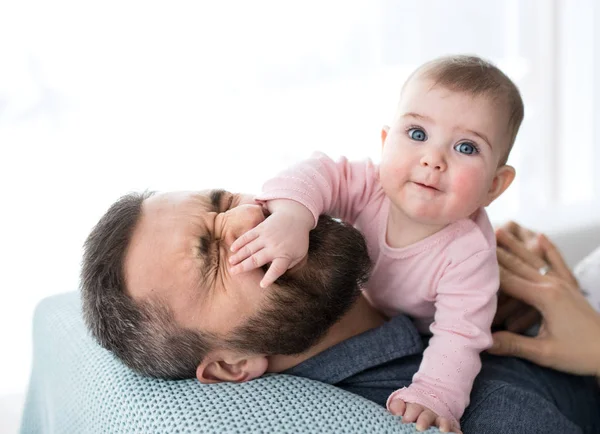 Mature father playing with baby daughter sitting indoors, having fun. — Stock Photo, Image