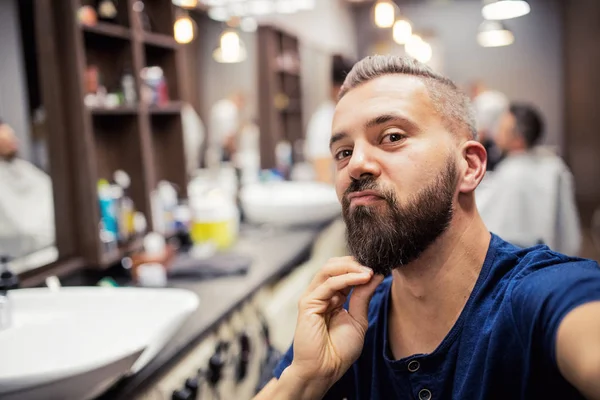 Hipster-Mann besucht Friseur und Friseur im Friseursalon. — Stockfoto