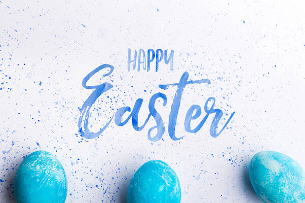 Happy Easter flat lay on a white background.