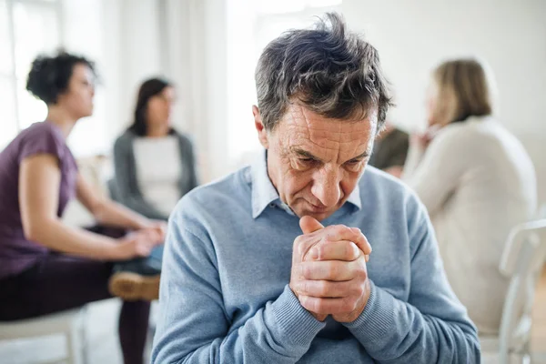 A portrait of senior depressed man during group therapy. — Stock Photo, Image