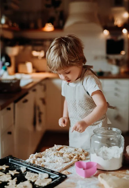 A happy small toddler boy making cakes at home. — Stock Photo, Image