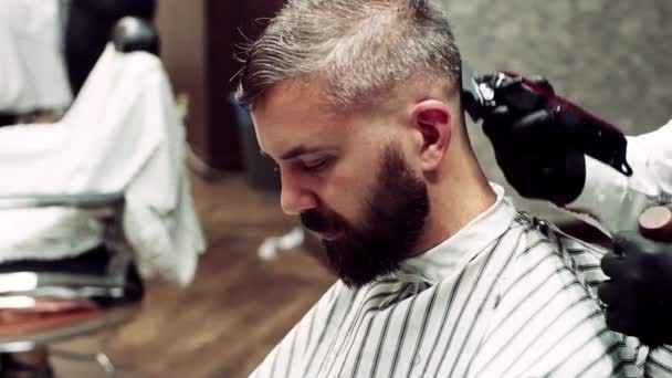 Hipster man client visiting haidresser and hairstylist in barber shop. — Stock Video