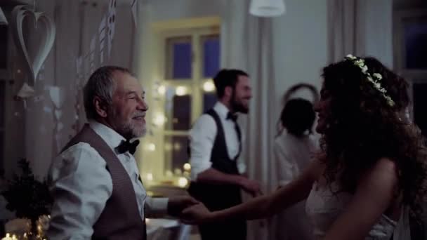 A young bride dancing with grandfather and other guests on a wedding reception. — Stock Video