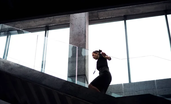 Una giovane donna d'affari che sale le scale nell'edificio degli uffici . — Foto Stock