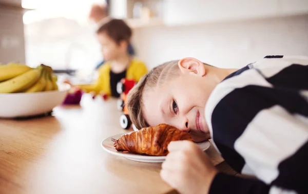 Dos niños pequeños con madre en una cocina, divirtiéndose . — Foto de Stock