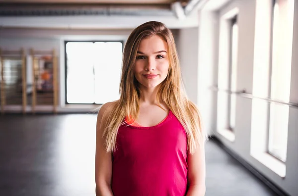Ein Porträt eines jungen Mädchens oder einer jungen Frau in einem Fitnessstudio. Kopierraum. — Stockfoto