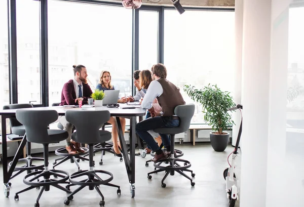 A group of business people sitting in an office, having meeting. — Stock Photo, Image