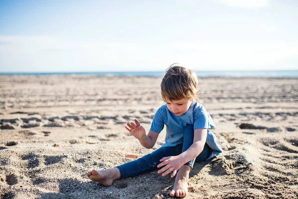 Mała dziewczynka gra w piasku na zewnątrz na plaży. — Zdjęcie stockowe