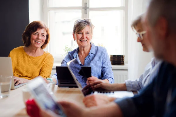 Grupp av seniora personer som använder bärbara datorer och surfplattor i Community Center Club. — Stockfoto