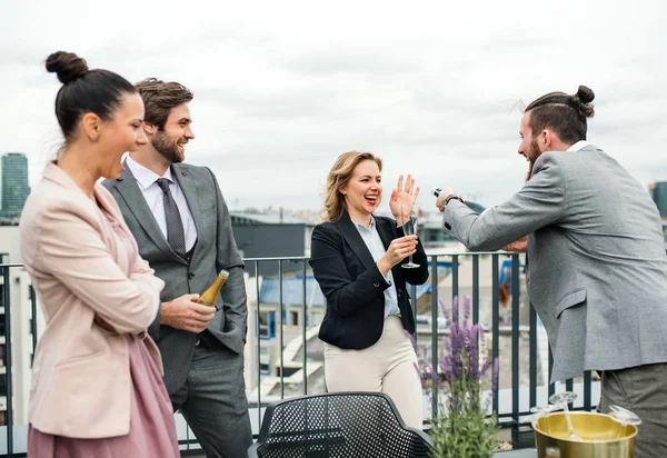 Un grupo de empresarios alegres haciendo una fiesta al aire libre en la azotea de la ciudad . —  Fotos de Stock