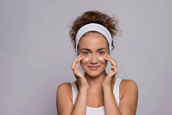 A portrait of a young woman with collagen pads in a studio, beauty and skin care. — Stock Photo, Image