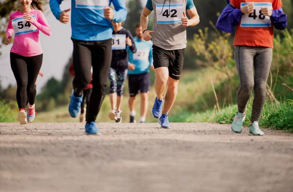 Midsection of large group of people running a race competition in nature. — Stock Photo, Image