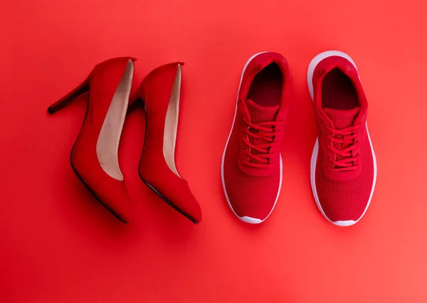 A studio shot of pair of running vs high heel shoes on color background. Flat lay. — Stock Photo, Image