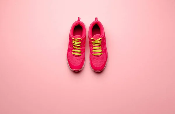 A studio shot of pair of running shoes on pink background. Flat lay. — Stock Photo, Image