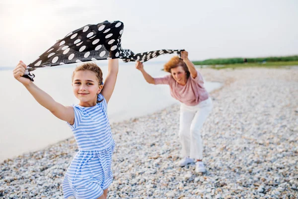 Kleines Mädchen mit Großmutter im Urlaub am See, Spaß haben. — Stockfoto