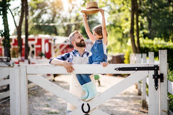 Un retrato del padre con una hija pequeña al aire libre en la granja familiar . —  Fotos de Stock