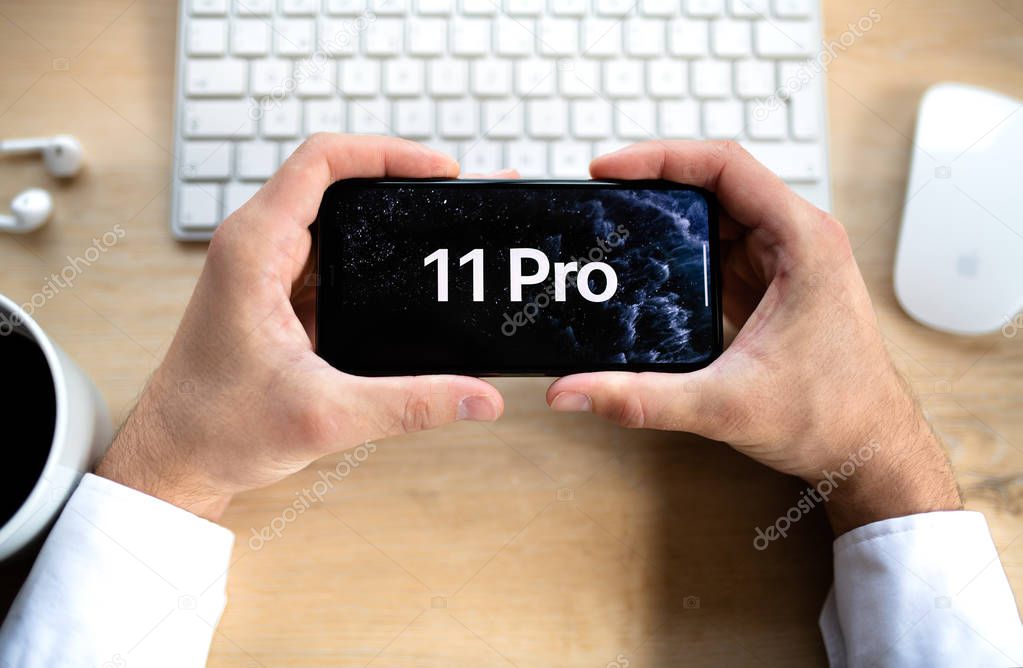 NOVA BANA, SLOVAKIA - SEPT 25, 2019: Unrecognizable man holding a new Apple iPhone 11 Pro smartphone.