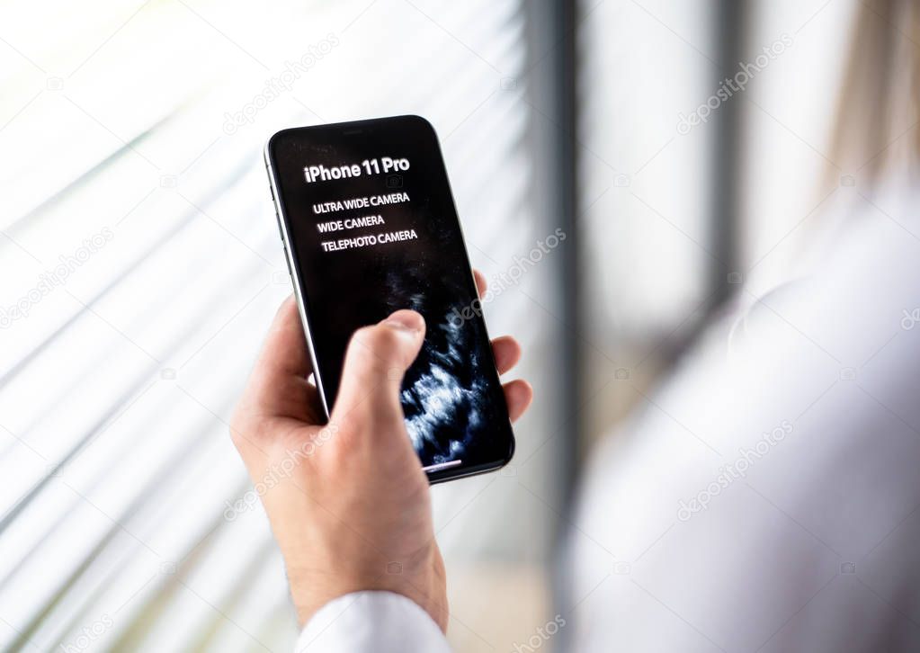 NOVA BANA, SLOVAKIA - SEPT 25, 2019: A male hand holding a new Apple iPhone 11 Pro smartphone.