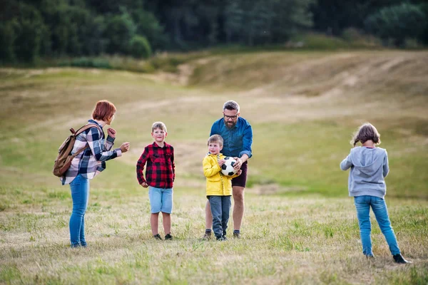 Grupo de escolares con profesor en excursión en la naturaleza, jugando con una pelota . — Foto de Stock