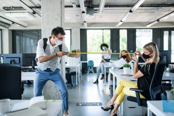 Jongeren met gezichtsmaskers weer aan het werk na vergrendeling, meetafstand. — Stockfoto