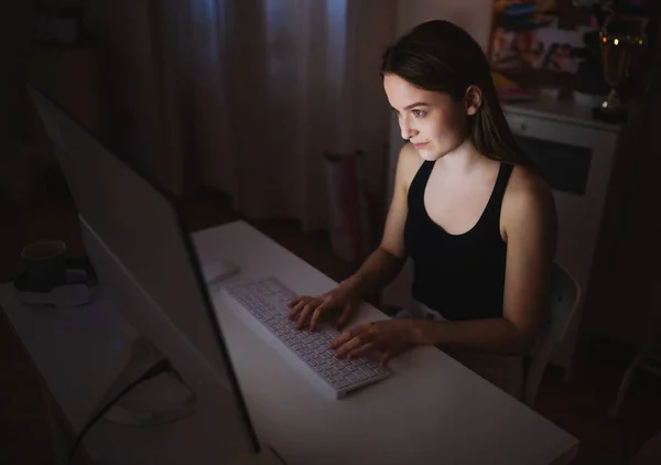 Glad ung flicka med dator på natten leende, online dejting koncept. — Stockfoto