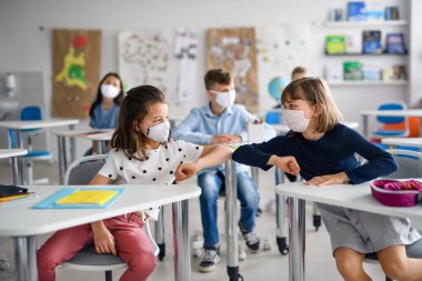 Covid-19 karantina ve tecritten sonra maskeli çocuklar okula geri döndü..