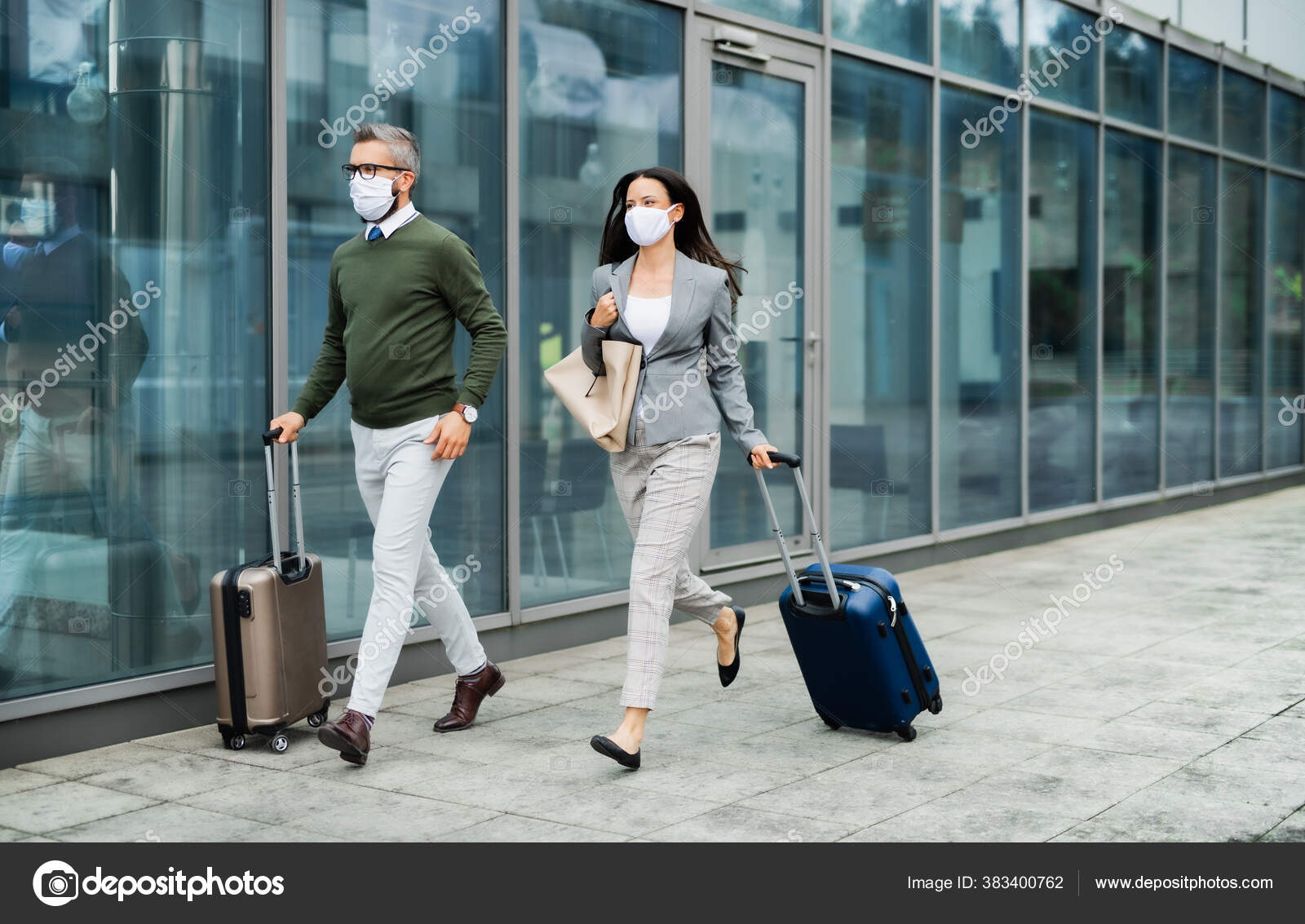 Businesspeople with luggage going on business trip, wearing face
