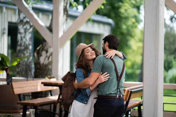 Happy couple greeting outdoors on terrace restaurant, end of lockdown. — Stock Photo, Image