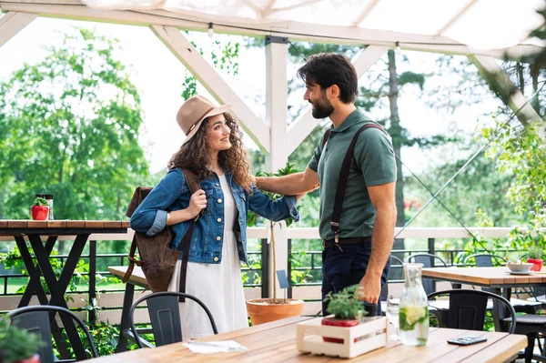 Happy couple greeting outdoors on terrace restaurant, end of lockdown. — Stock Photo, Image