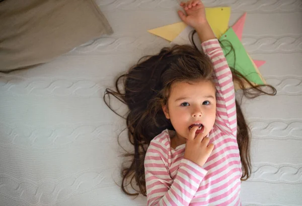 Top view portrait of small girl indoors, looking at camera. — Stock Photo, Image