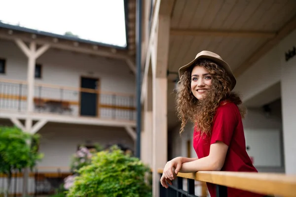 Jeune femme debout à l'extérieur sur le balcon de l'hôtel en vacances, relaxant. — Photo