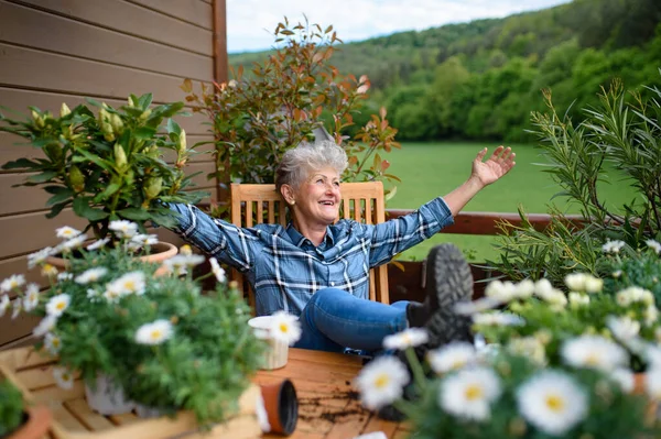 Nenek senior berkebun di balkon di musim panas, beristirahat. — Stok Foto