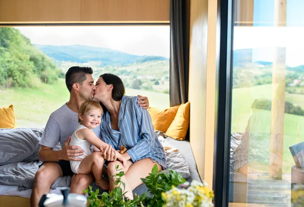 Familia joven con hija pequeña en el interior, fin de semana en casa contenedor en el campo. — Foto de Stock